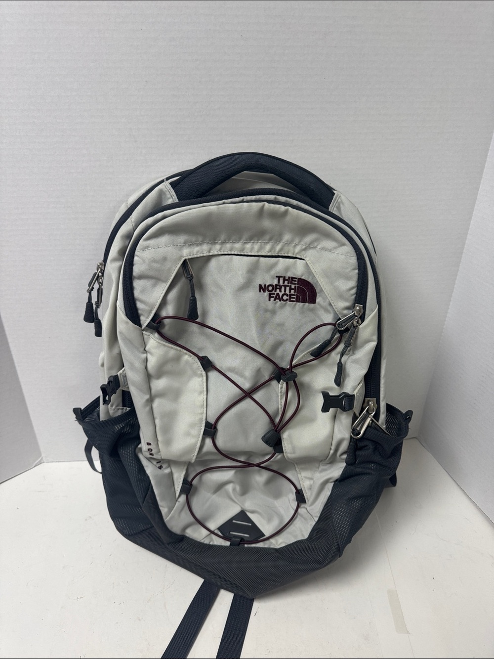 The North Face White and Black Backpack with Maroon Bungee